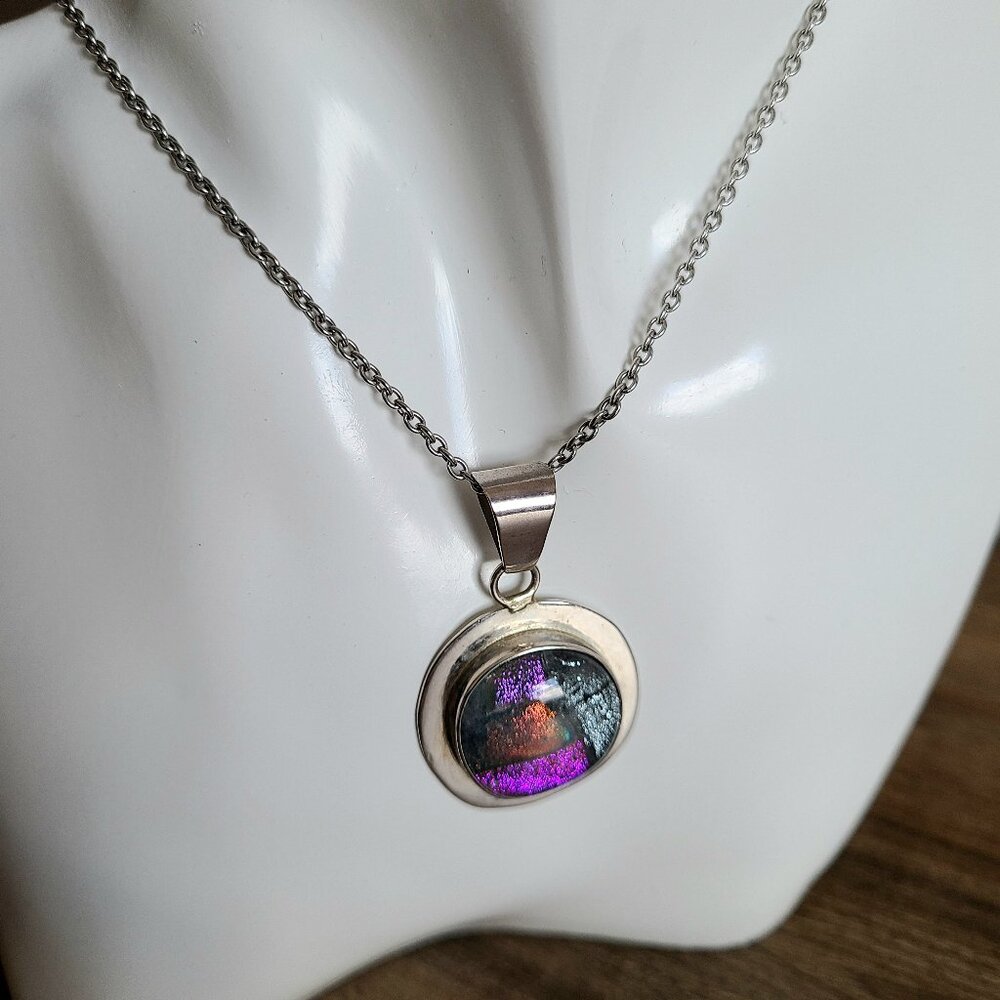 Silver pendant with multicolored dichroic glass.